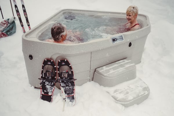 Older couple enjoying their 3-person Tristar in the snow. 